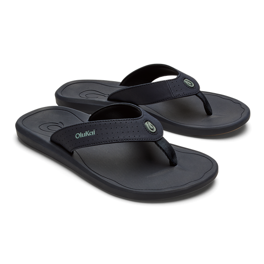 Pair of dark blue OluKai Ki'i flip-flops with textured footbeds and fabric thong straps.