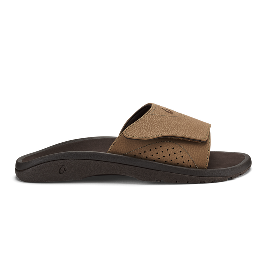 Tan and dark brown slide sandal with perforated upper and dark sole, shown from the side.