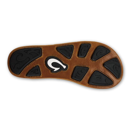 Tan and dark brown sole with black textured patches and white curved logo in center.
