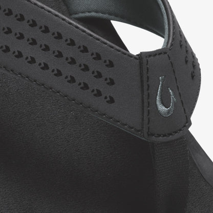 Black sports bra with perforated panel detailing, adjustable straps, and swoosh logo.