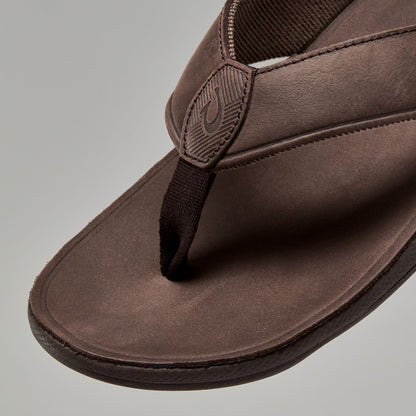 Dark brown suede thong sandal with embroidered strap detail and cushioned sole.