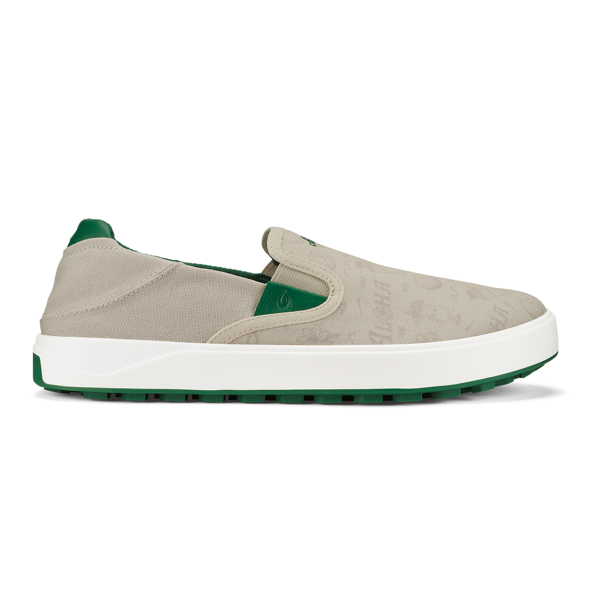 Beige canvas slip-on sneaker with white midsole and green heel counter and outsole.