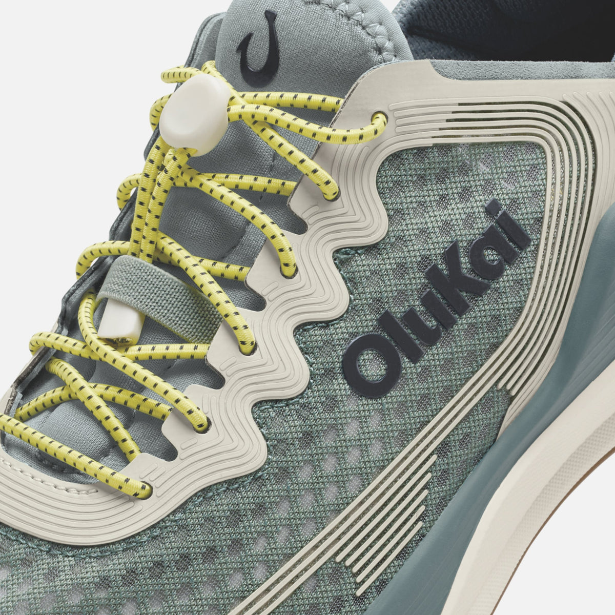 Seagreen and white athletic shoe with yellow laces and "ōnki" branding on the side panel.