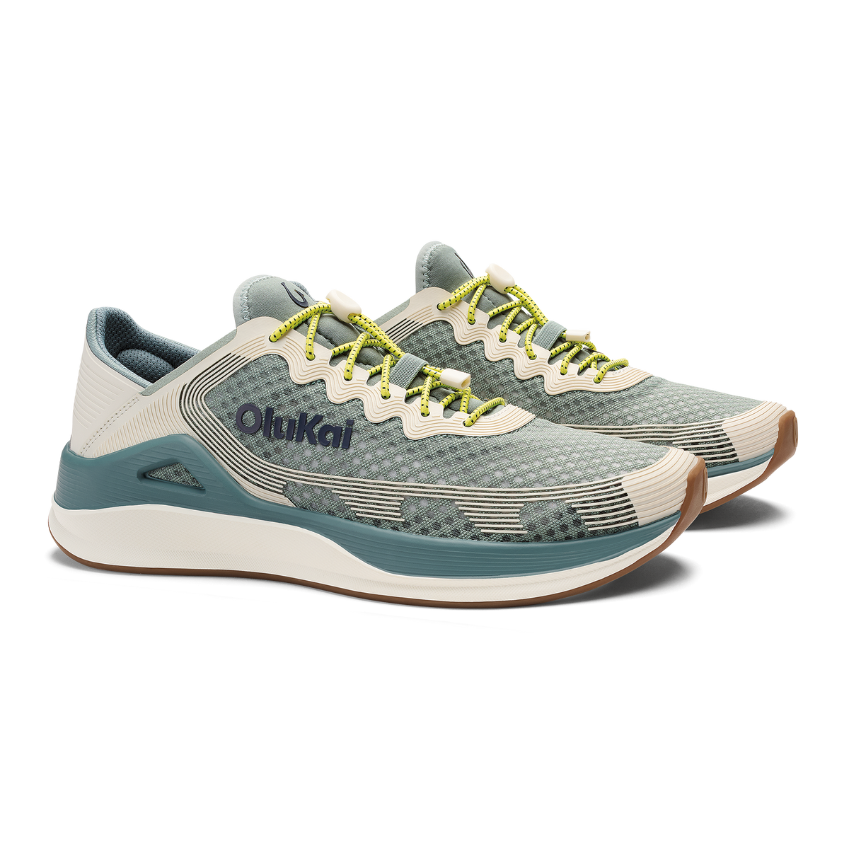 Pair of seagreen and white sand running shoes with yellow laces and brown heel accent.