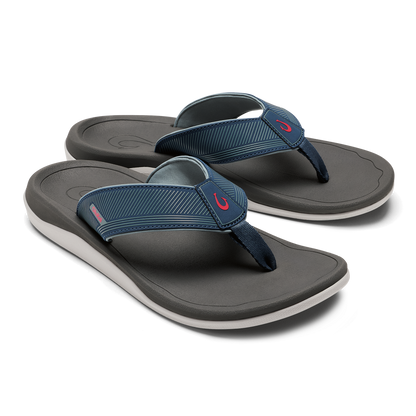 Pair of dark gray and blue thong sandals with white midsoles and striped fabric straps.