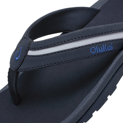 Dark blue and pale gray thong sandal with blue embroidered branding and cushioned footbed detail visible.
