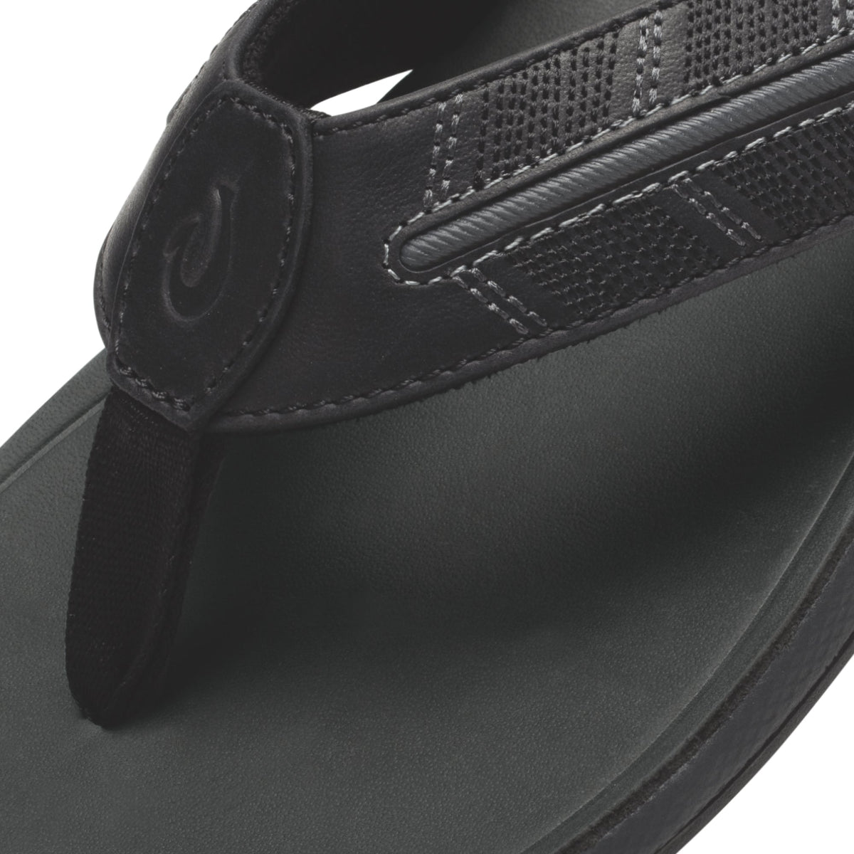 Black thong sandal with textured upper strap and cushioned footbed, shown from above.