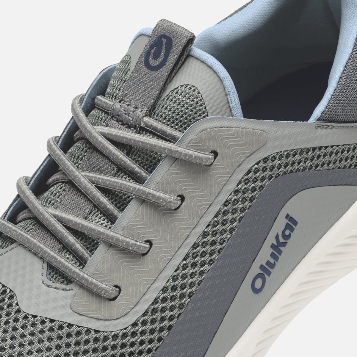 Charcoal and light blue athletic shoe with mesh panels, textured sole, and gray laces.