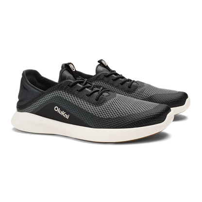 Black mesh athletic shoe with white sole and OluKai branding on the side.