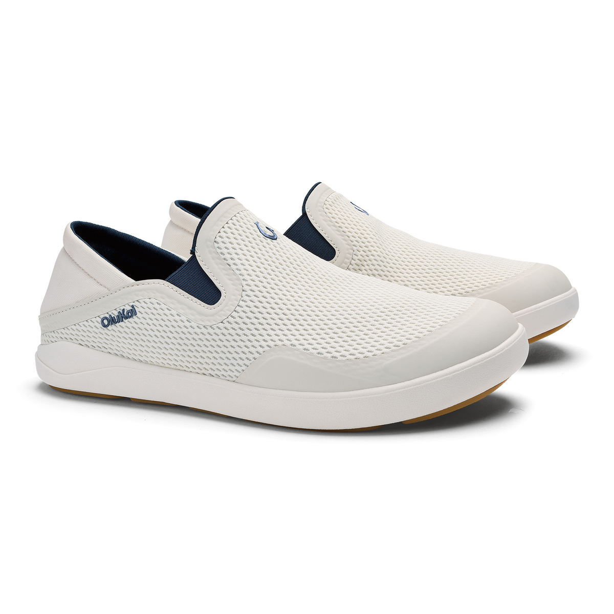 White and navy blue slip-on shoe with textured mesh upper and white cushioned sole.