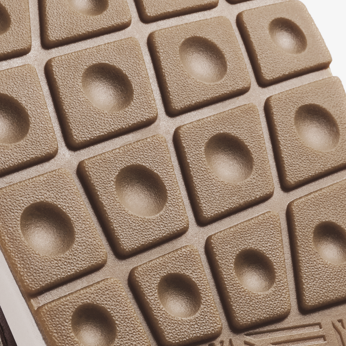 Ecru and taupe grey modular tiles with textured surfaces and circular indentations arranged in a grid pattern.