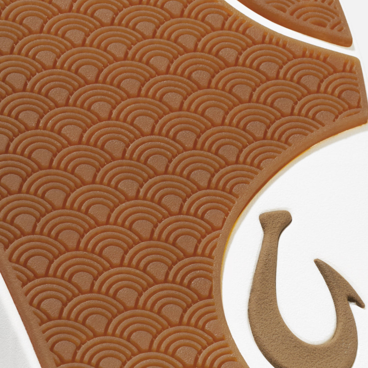Tan sole with concentric arc pattern and tan hook symbol detail on white background.