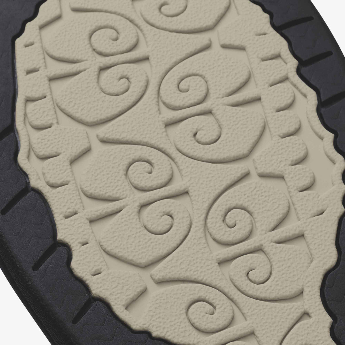 Ecru cushioned insole with embossed spiral pattern and black rubber sole visible from above.