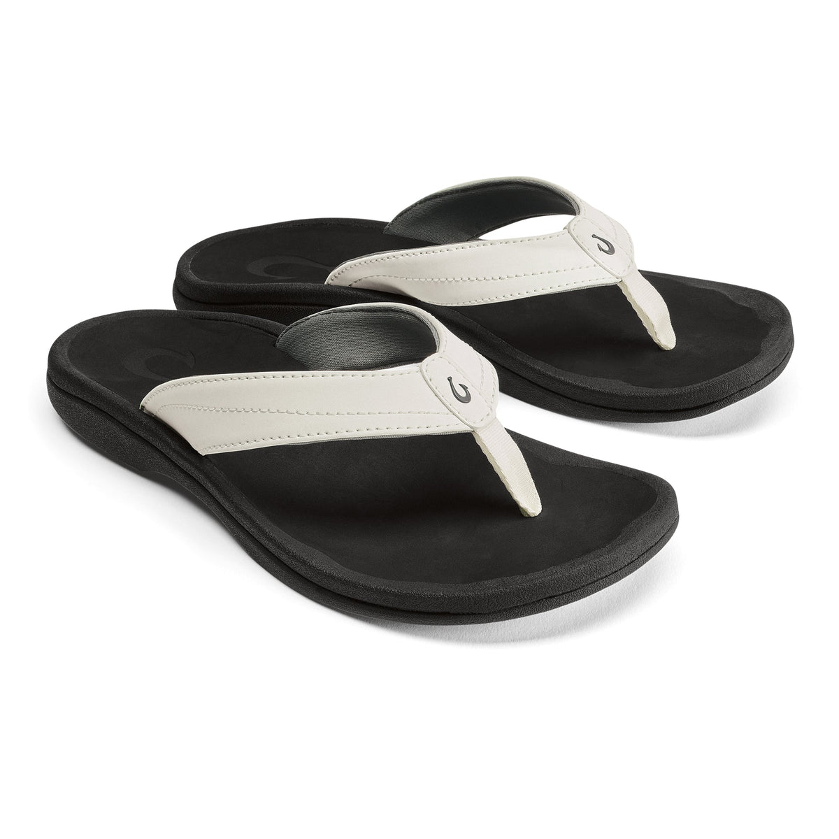 Pair of black flip-flops with bright white thong straps and black padded soles.