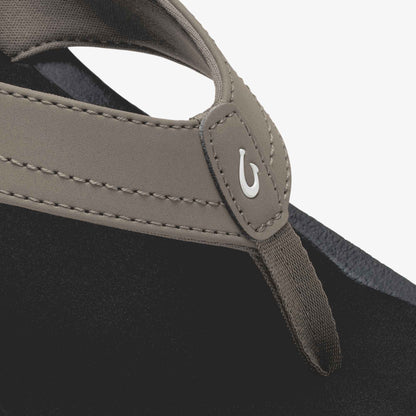 Warm taupe and black tote bag with dual handles and white brand logo detail on front panel.