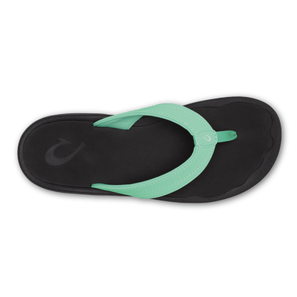 Flip-flop with mint green thong strap and black sole, viewed from above.