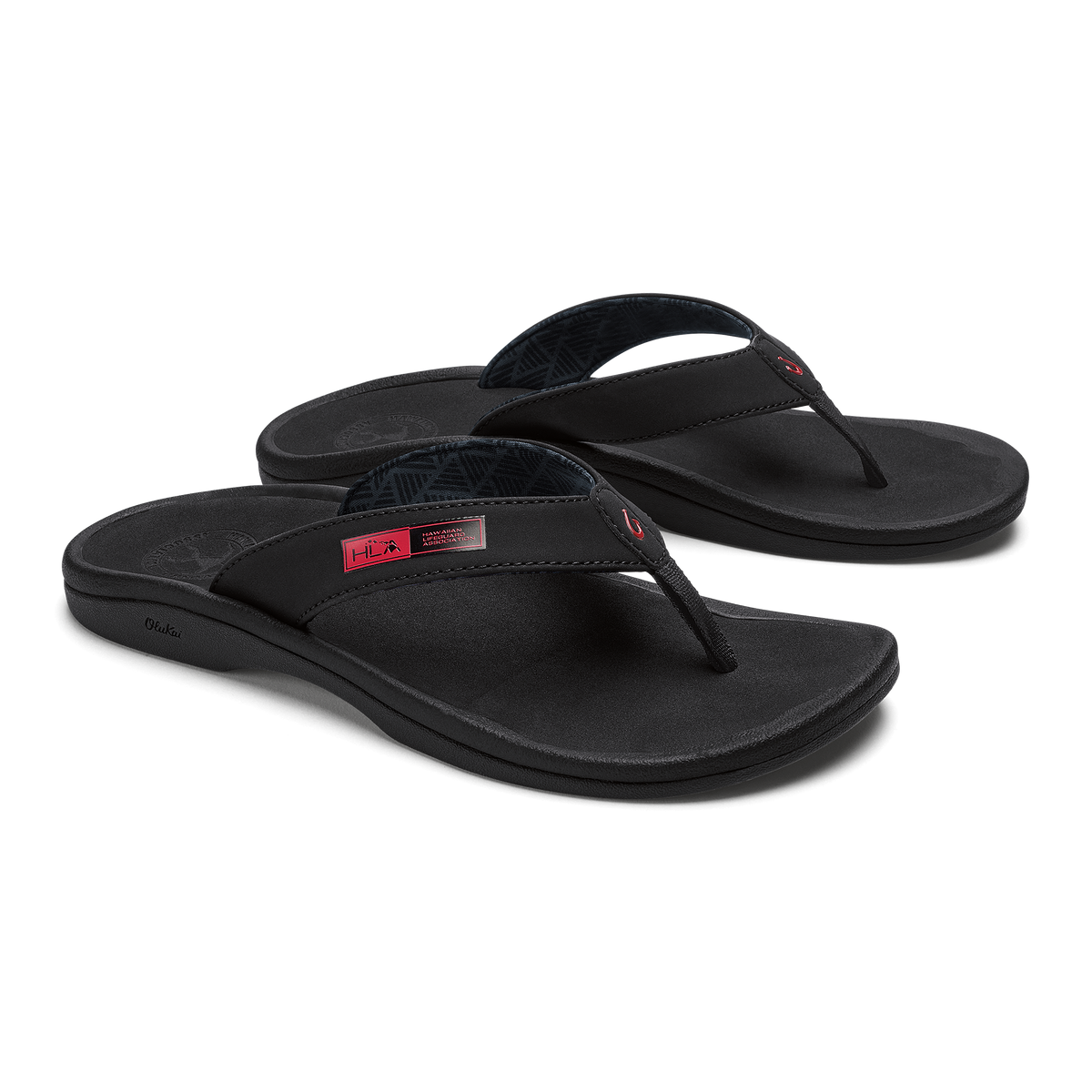 Pair of black thong sandals with contoured footbeds and red accent labels on the straps.
