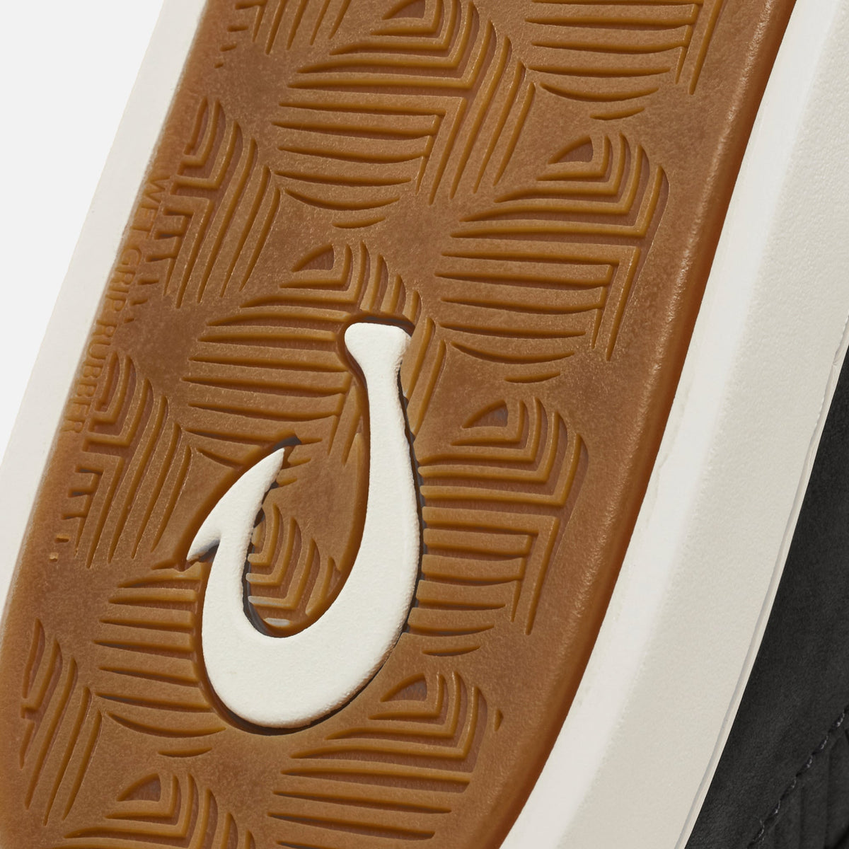 Tan rubber sole with geometric line pattern and white hook detail.