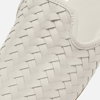 Cream-colored woven leather bag with interlocking basket weave pattern and curved handle detail.