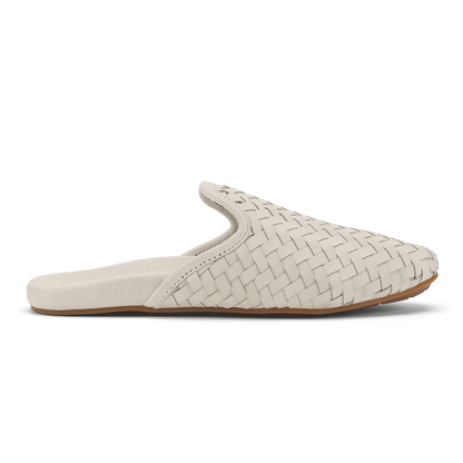 Cream-colored woven leather mule slipper with tan sole, shown in profile view.