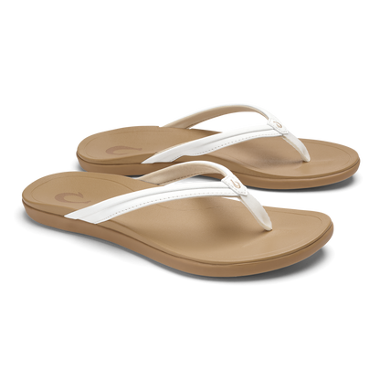 Pair of tan and white thong flip-flops with cushioned footbeds and white straps.