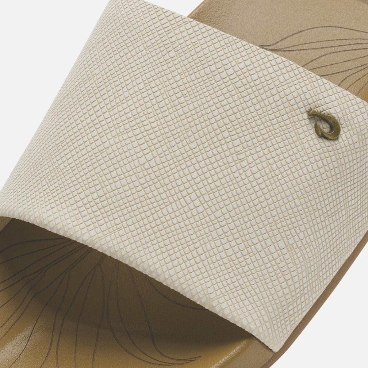 Cream-colored fabric with fine crosshatch pattern and curved line details, featuring a button closure.