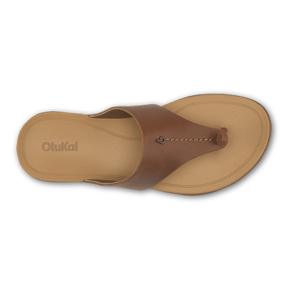 Tan and brown leather thong sandal with decorative circular detail, viewed from above.