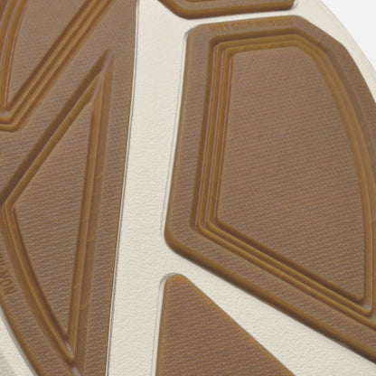 Tan and cream-colored shoe sole with geometric raised line pattern and textured surface.