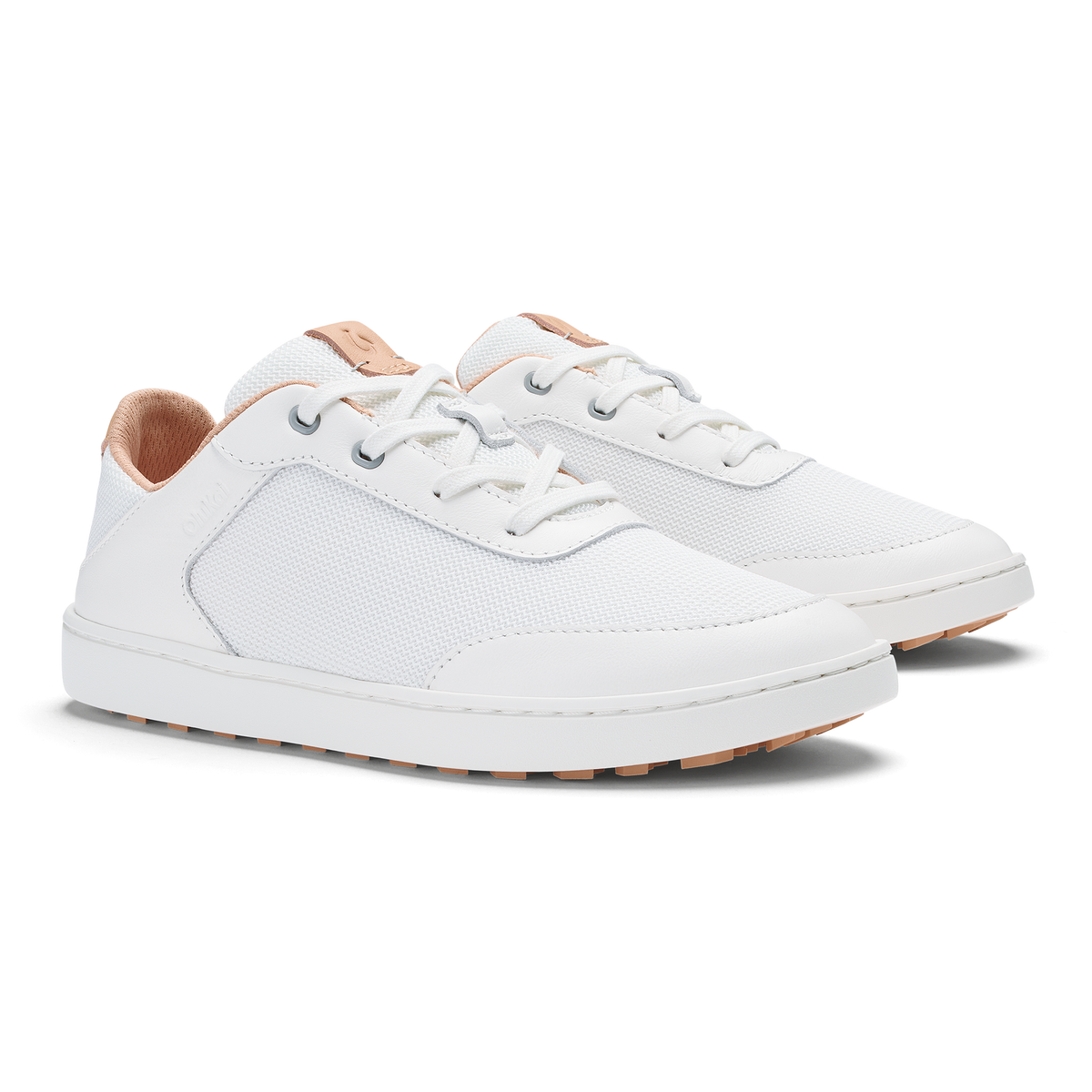 Pair of white lace-up sneakers with cantalope-colored heel and sole accents, shown from the side.