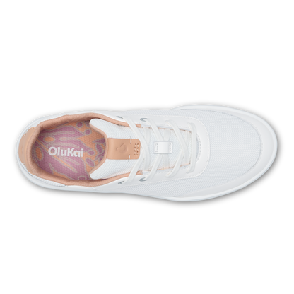 White athletic shoe with cantalope-colored heel tab and insole, viewed from above.