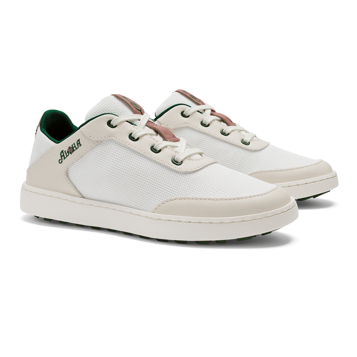 Pair of white lace-up sneakers with cream and beige panels, brown heel accents, and green interior lining.