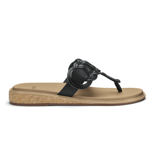 Black and warm sand flip-flop sandal with decorative knot detail and cork-textured sole.