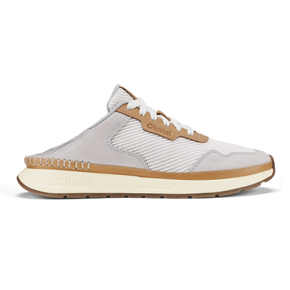 White and tan slip-on sneaker with mesh paneling, white laces, and cream-colored sole.