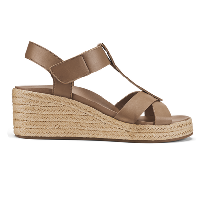 Tan leather wedge sandal with crossed straps, ankle strap, and woven espadrille sole.