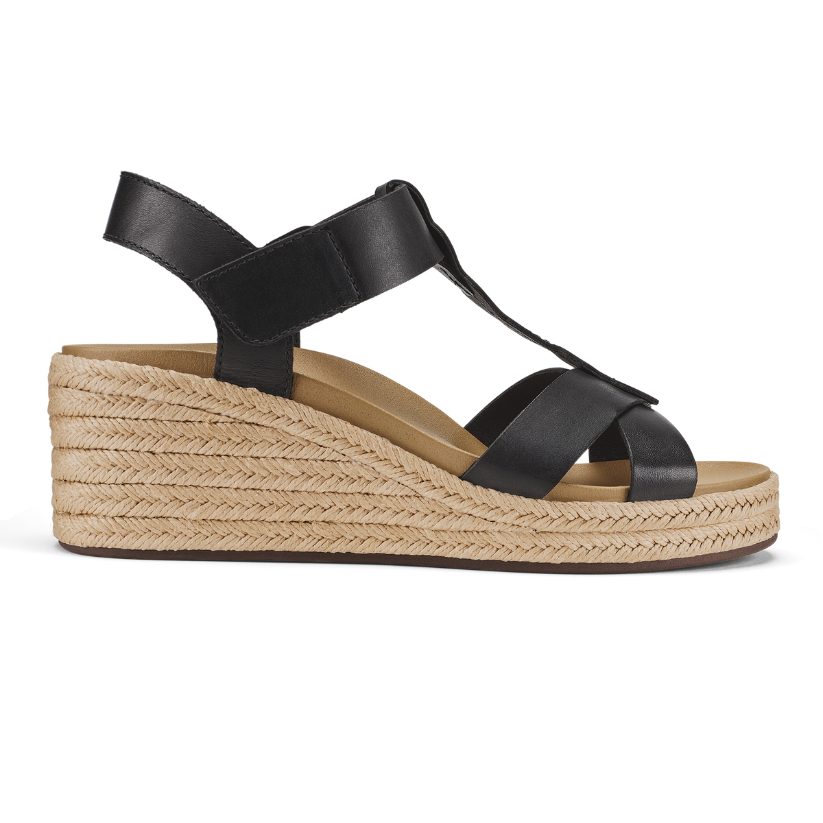 Black leather T-strap sandal with woven jute wedge heel and warm sand-colored suede footbed.