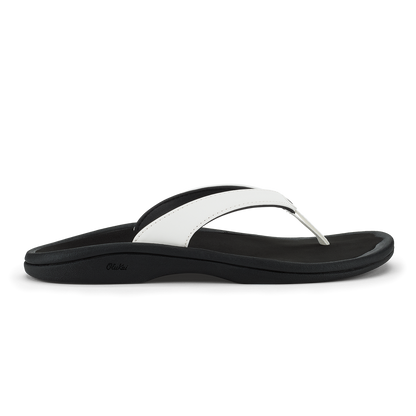 Black and white thong sandal with curved footbed and contrasting strap design.