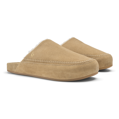 Pair of tan suede slip-on mules with stitched seams and rounded toe design.