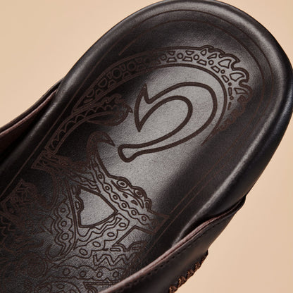 Dark brown leather shoe with embossed number 5 and ornamental geometric patterns on the sole.